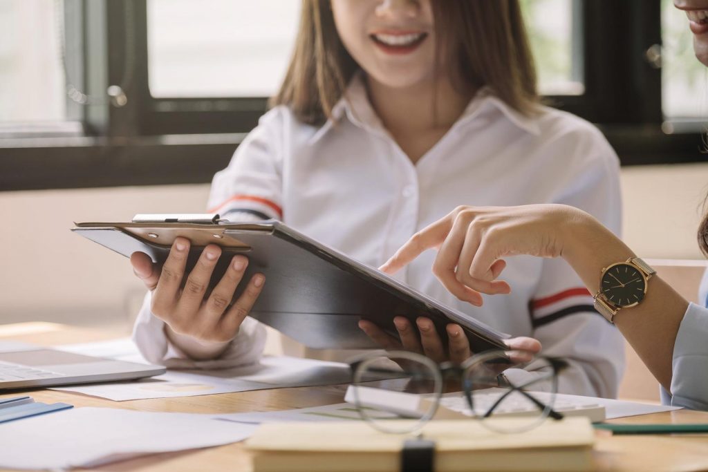 Young business teamwork working with business report document on office desk